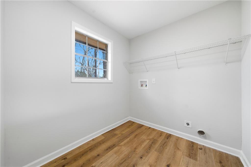 7258 Banks Mill Road Douglasville, GA 30135 - Photo 8 of 23 a view of an empty room with wooden floor and a window