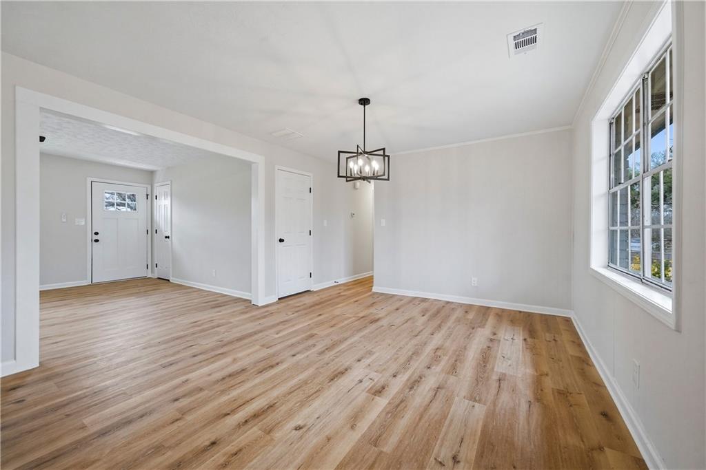 7258 Banks Mill Road Douglasville, GA 30135 - Photo 9 of 23 a view of empty room with wooden floor