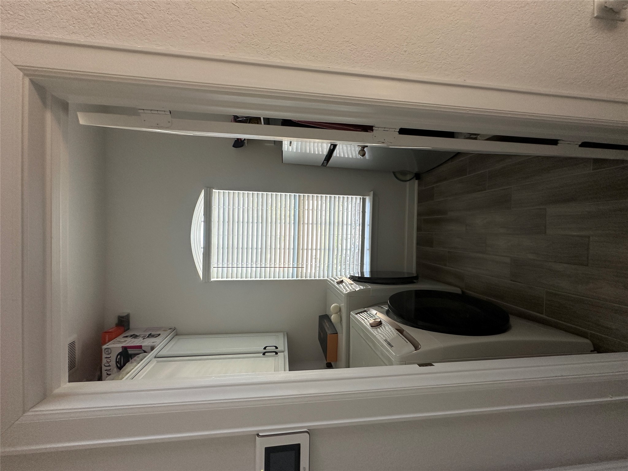650 Wild Pecan Loop Buda, TX 78610 - Photo 26 of 28 Laundry room with dark wood finished floors, washing machine and clothes dryer, and cabinet space