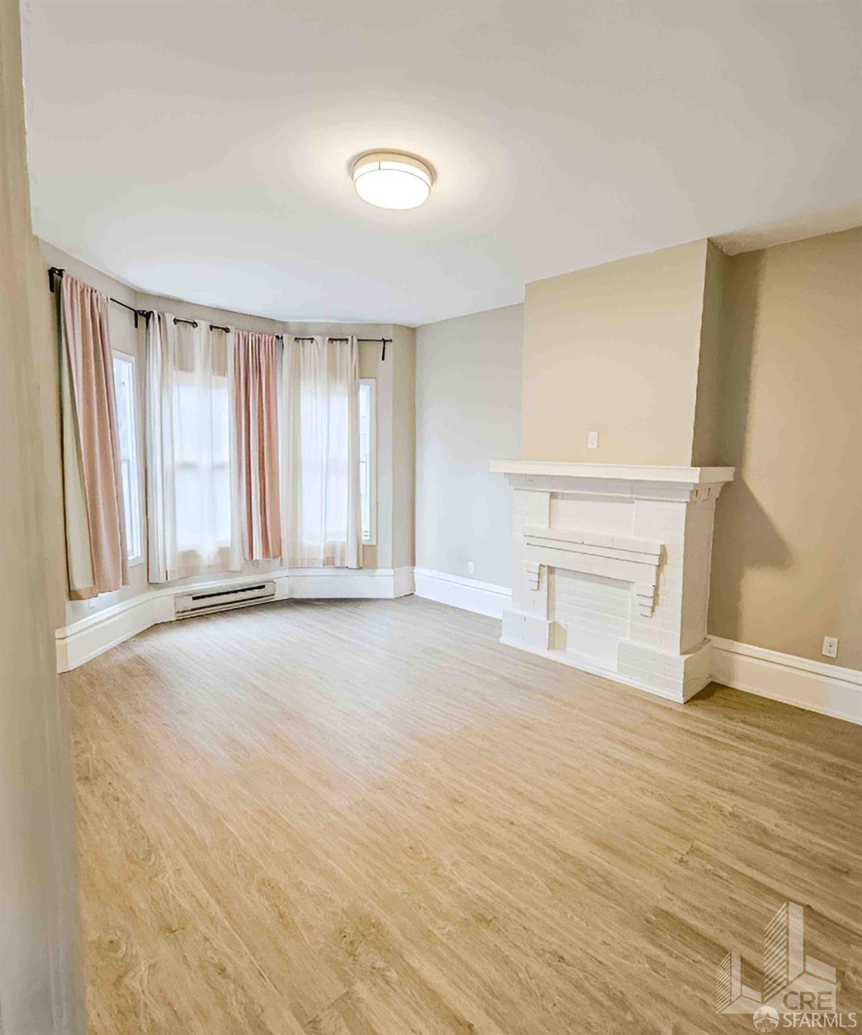 66-68 Moss Street San Francisco, CA 94103 - Photo 4 of 8 wooden floor in an empty room with a window