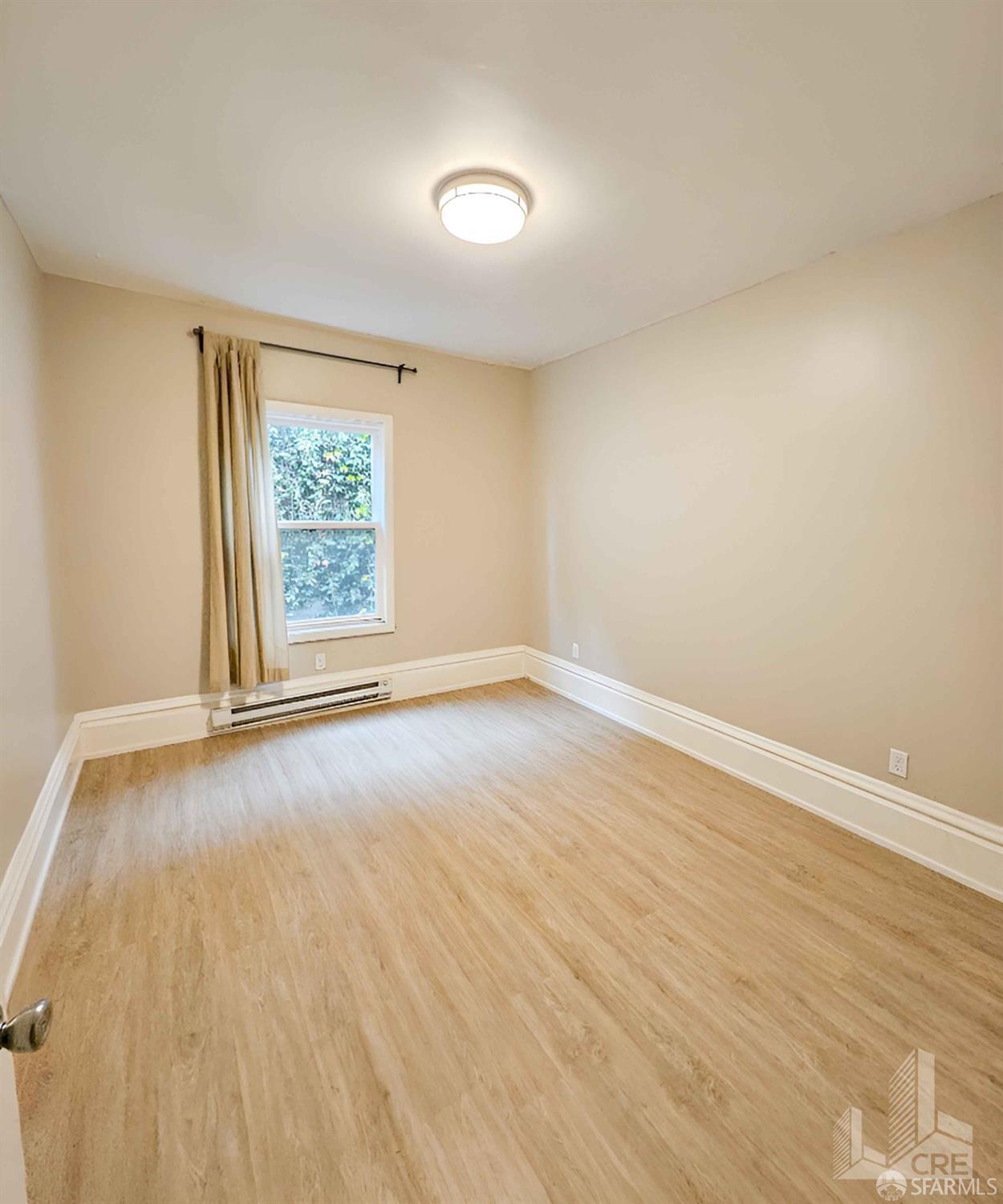 66-68 Moss Street San Francisco, CA 94103 - Photo 5 of 8 an empty room with wooden floor and windows