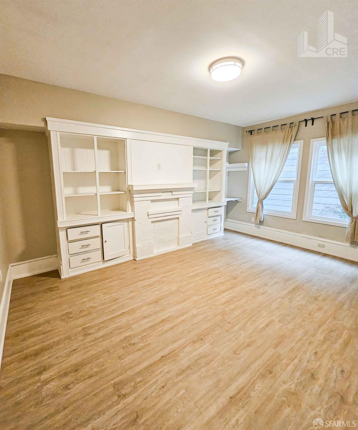 66-68 Moss Street San Francisco, CA 94103 - Photo 6 of 8 an empty room with cabinet and windows