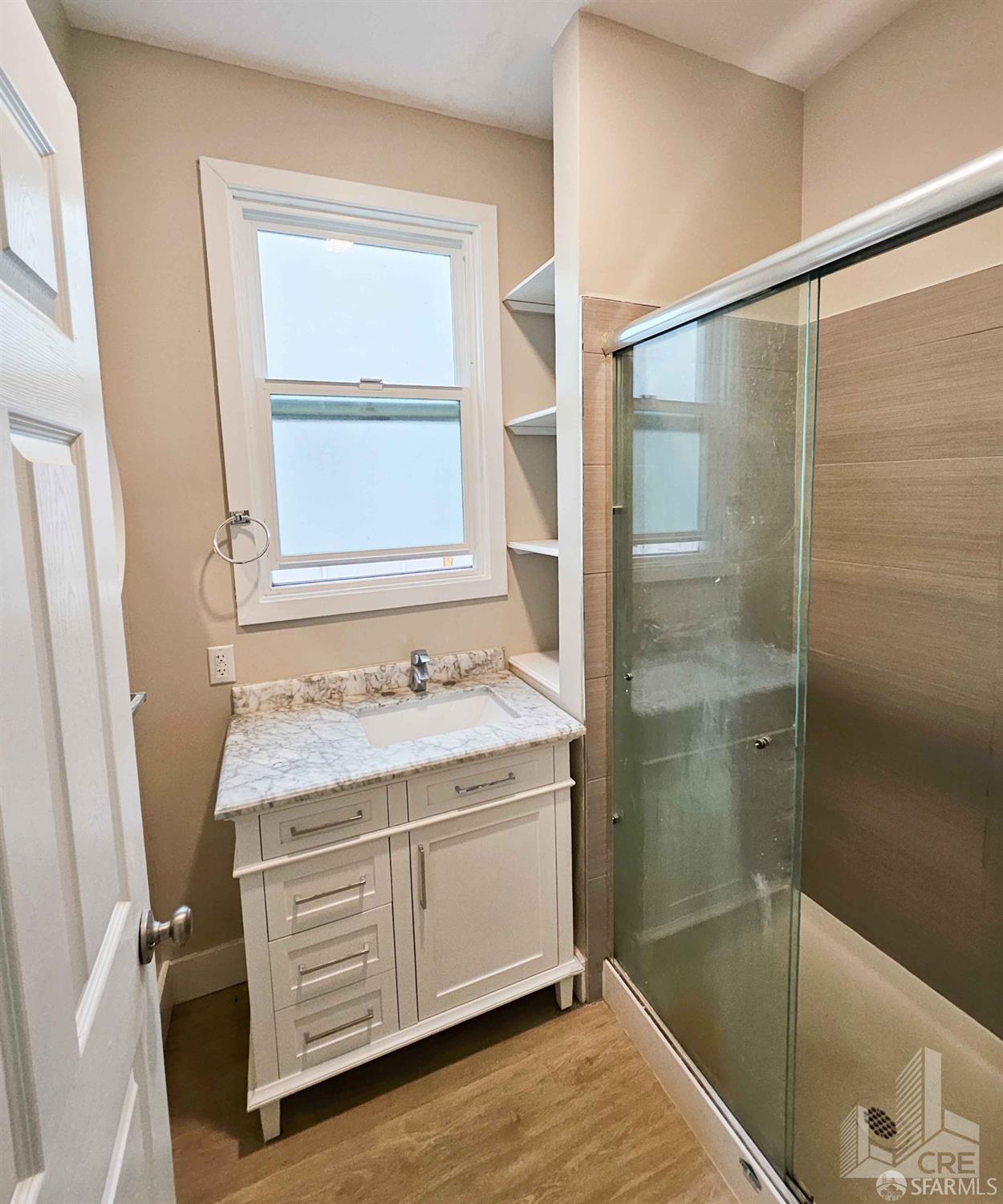 66-68 Moss Street San Francisco, CA 94103 - Photo 8 of 8 a bathroom with a granite countertop sink a mirror and a shower