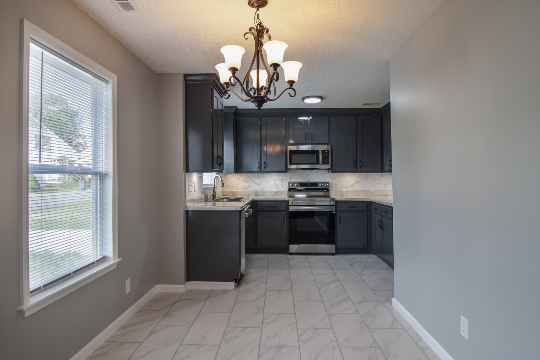 121 Popular Street North Cowan, TN 37318 - Photo 12 of 46 a kitchen with stainless steel appliances granite countertop a refrigerator and a sink
