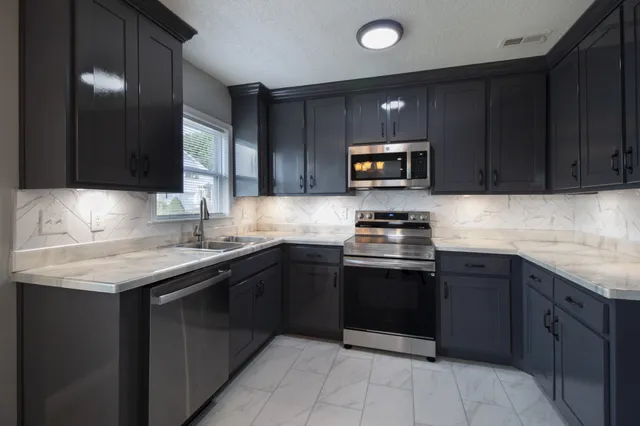 a kitchen with a sink and a stove