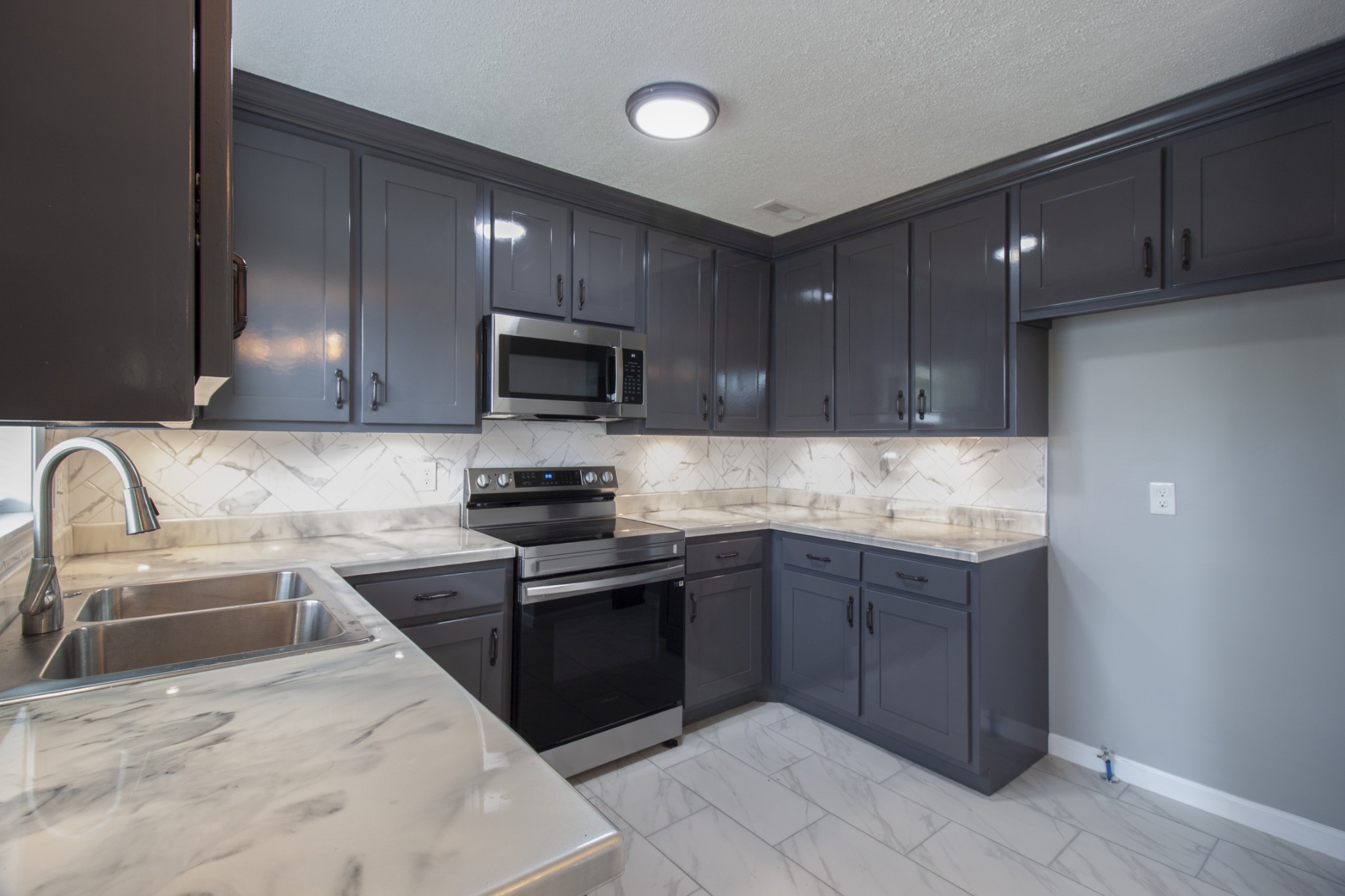121 Popular Street North Cowan, TN 37318 - Photo 15 of 46 a kitchen with granite countertop stainless steel appliances and wooden cabinets
