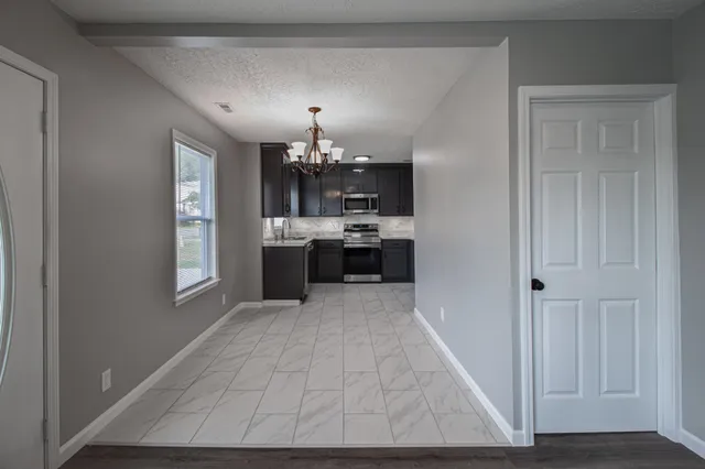 a view of a kitchen with a sink and dishwasher cabinets