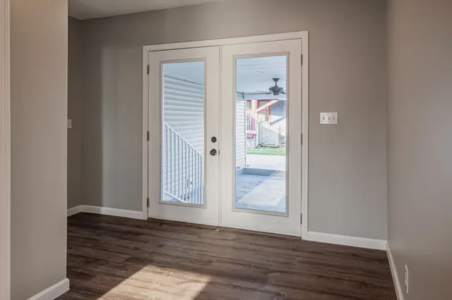 a view of an empty room with wooden floor
