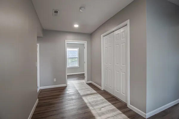 a view of hallway with wooden floor