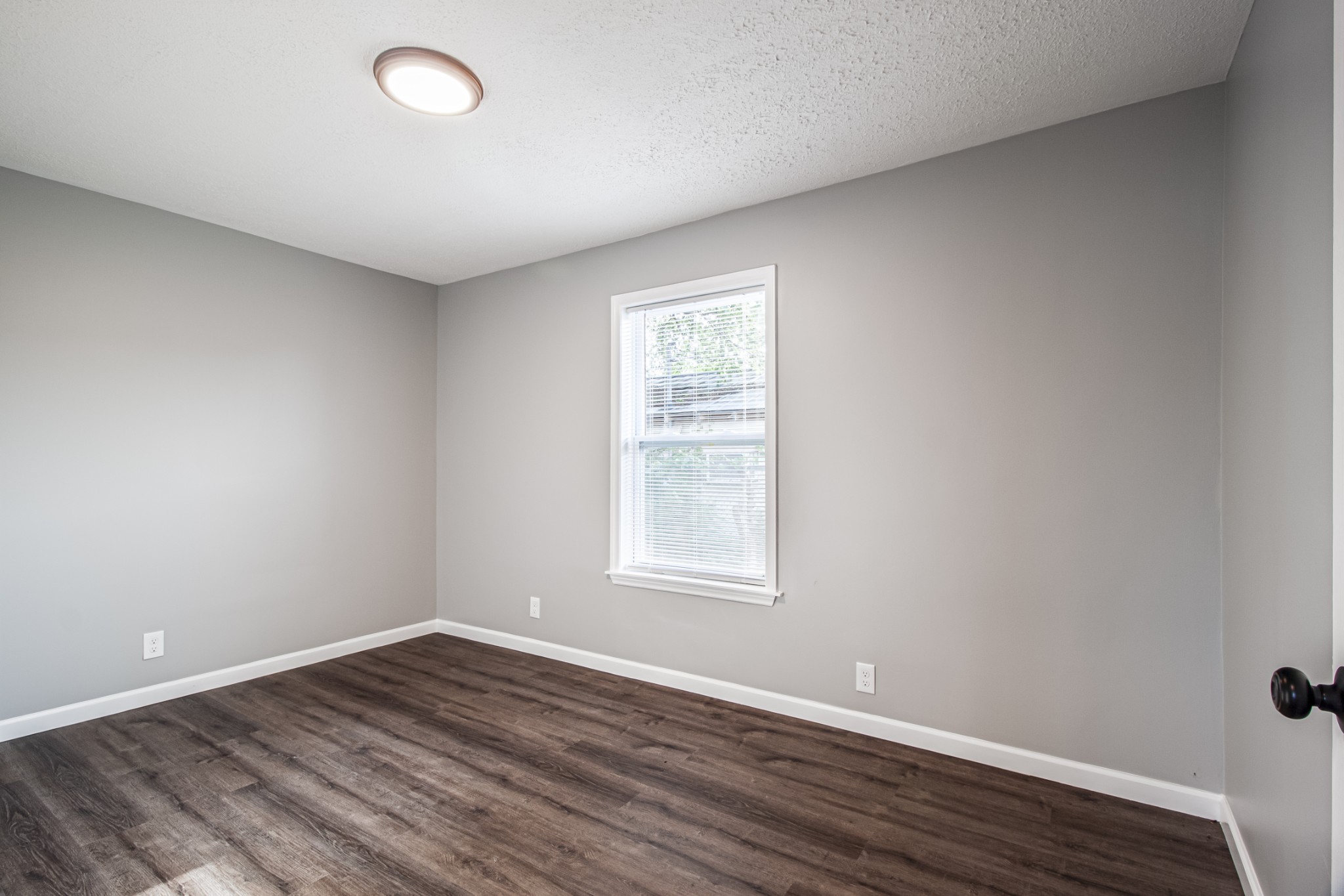 121 Popular Street North Cowan, TN 37318 - Photo 27 of 46 an empty room with wooden floor and windows
