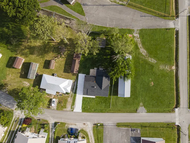 an aerial view of a house with a yard