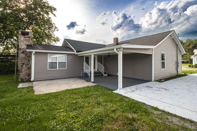 a view of a house with a yard and pathway