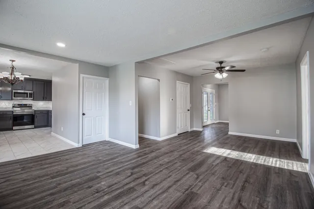 a view of an empty room with wooden floor
