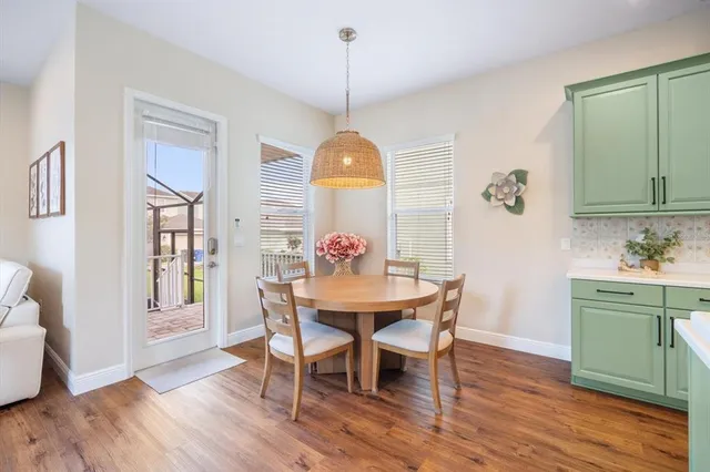 a view of a dining room with furniture window and wooden floor