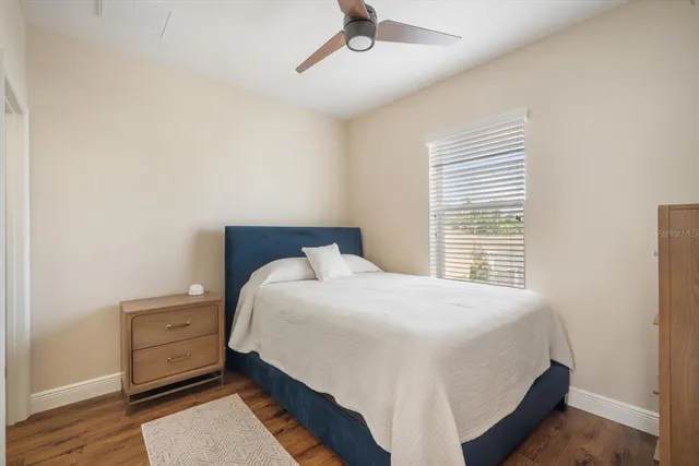 a bedroom with a bed and a night stand