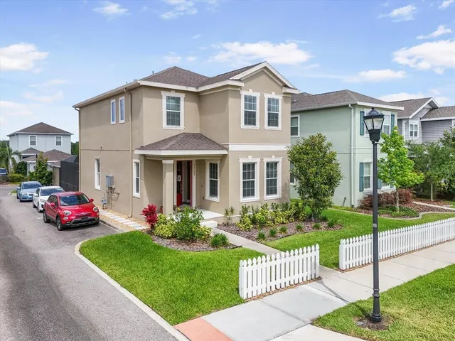 an aerial view of residential houses with yard and road