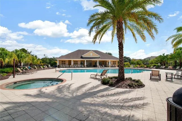 an aerial view of a house with swimming pool and mountain view