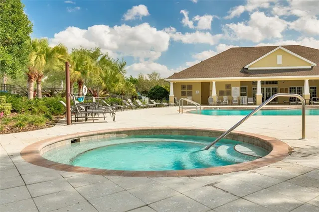 an outdoor space with swimming pool and furniture