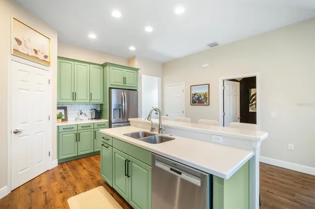 a kitchen with a sink and a refrigerator