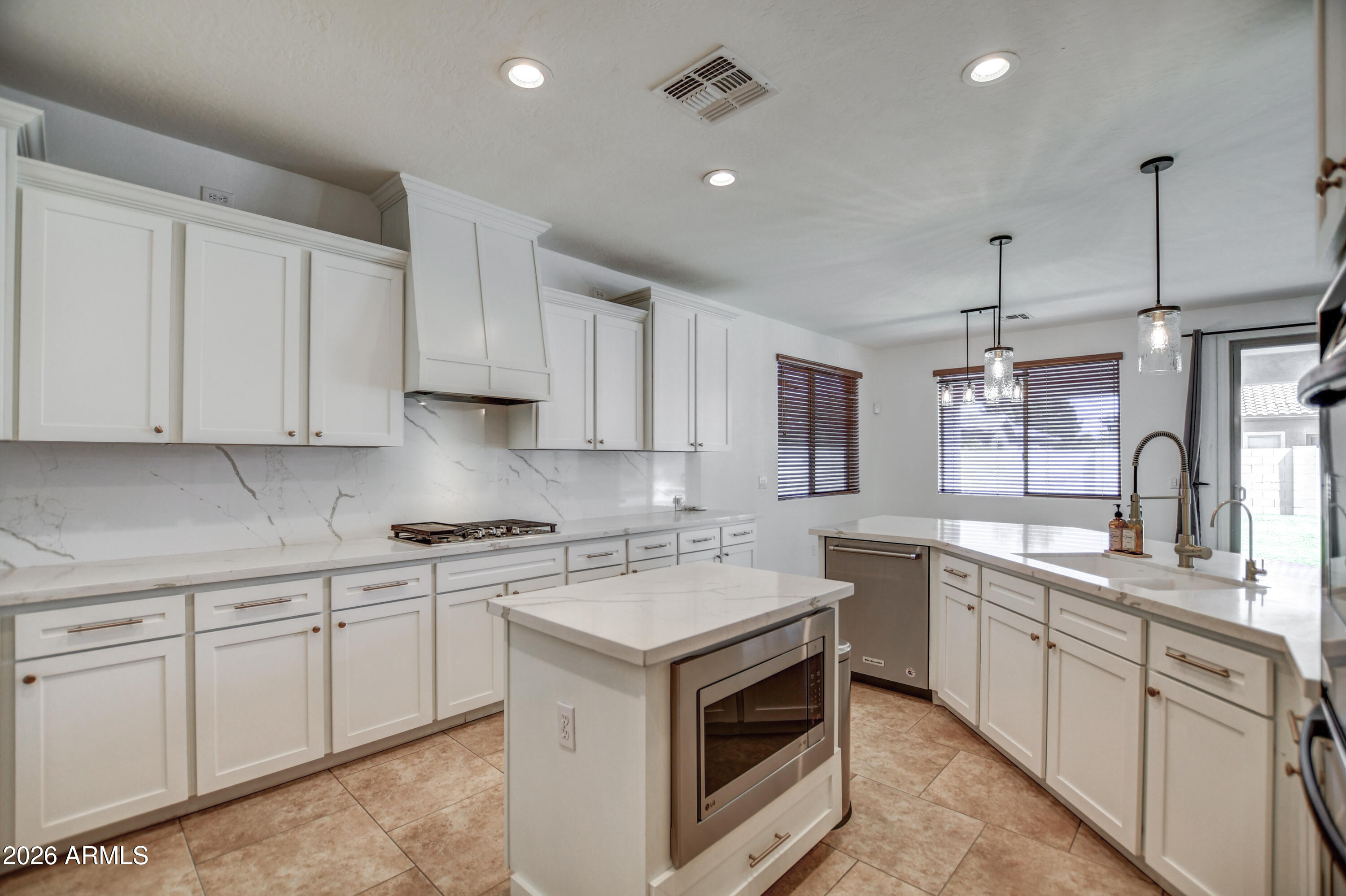 3078 East Muirfield Street Gilbert, AZ 85298 - Photo 41 of 92 a kitchen that has a sink and a stove in it