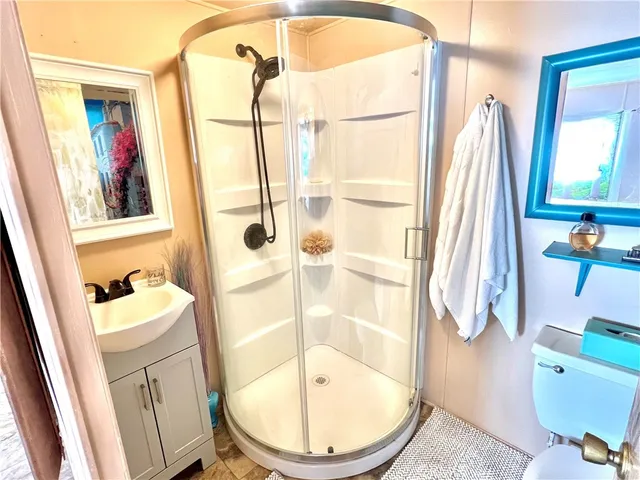 a bathroom with a sink toilet and mirror