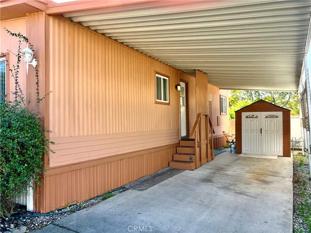 a view of a house with a backyard and a garden