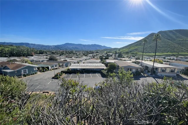 a view of swimming pool with outdoor seating and a garden