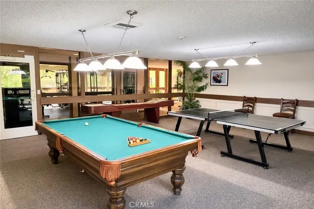 a living room with furniture and a book shelf