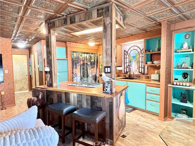 a dining room with furniture and a floor to ceiling window