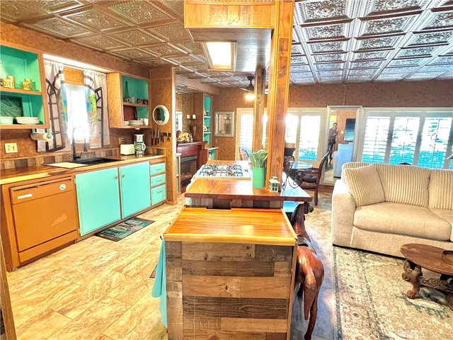 a living room with furniture a large window and dining table