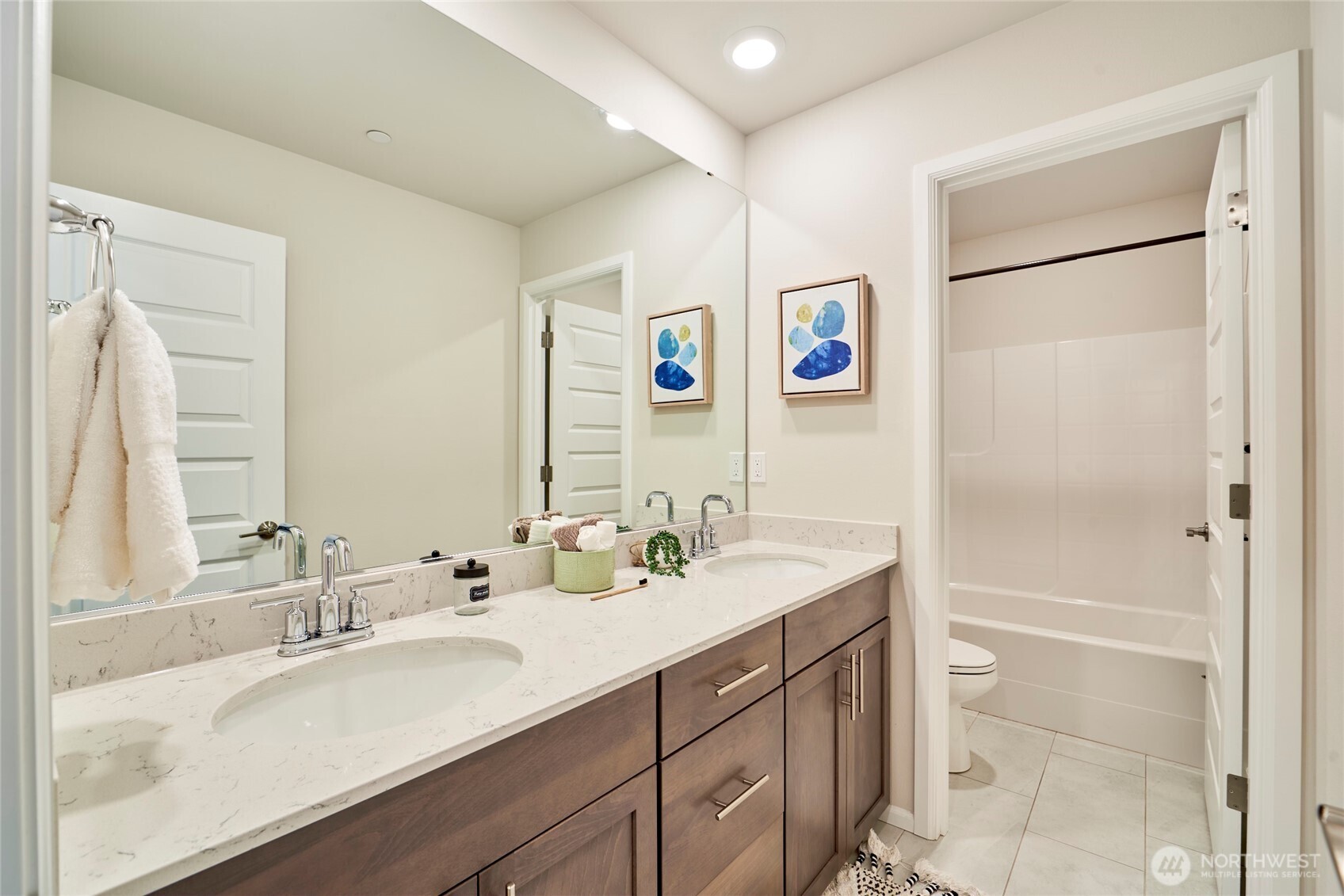 4022 233rd Street Southeast Bothell, WA 98021 - Photo 26 of 40 a bathroom with a sink a mirror a vanity and a shower
