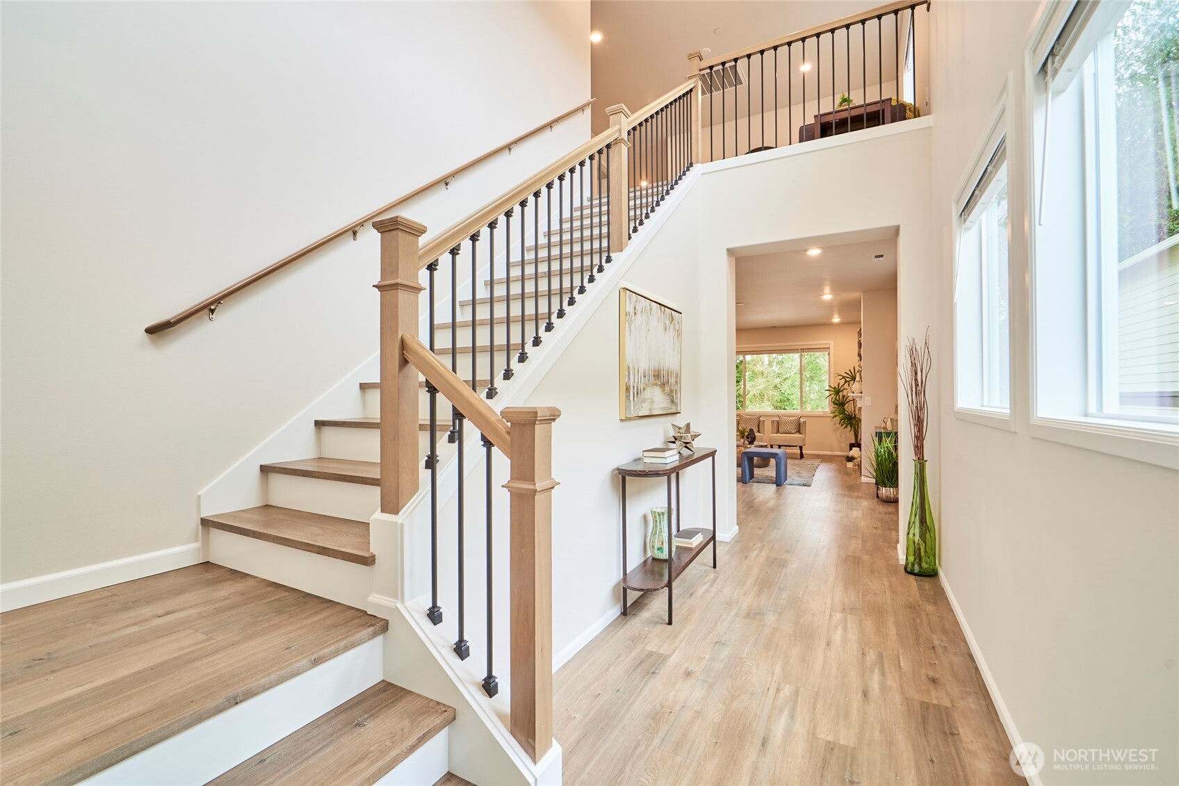 4022 233rd Street Southeast Bothell, WA 98021 - Photo 3 of 40 a view of staircase with lots of frames on wall and wooden floor