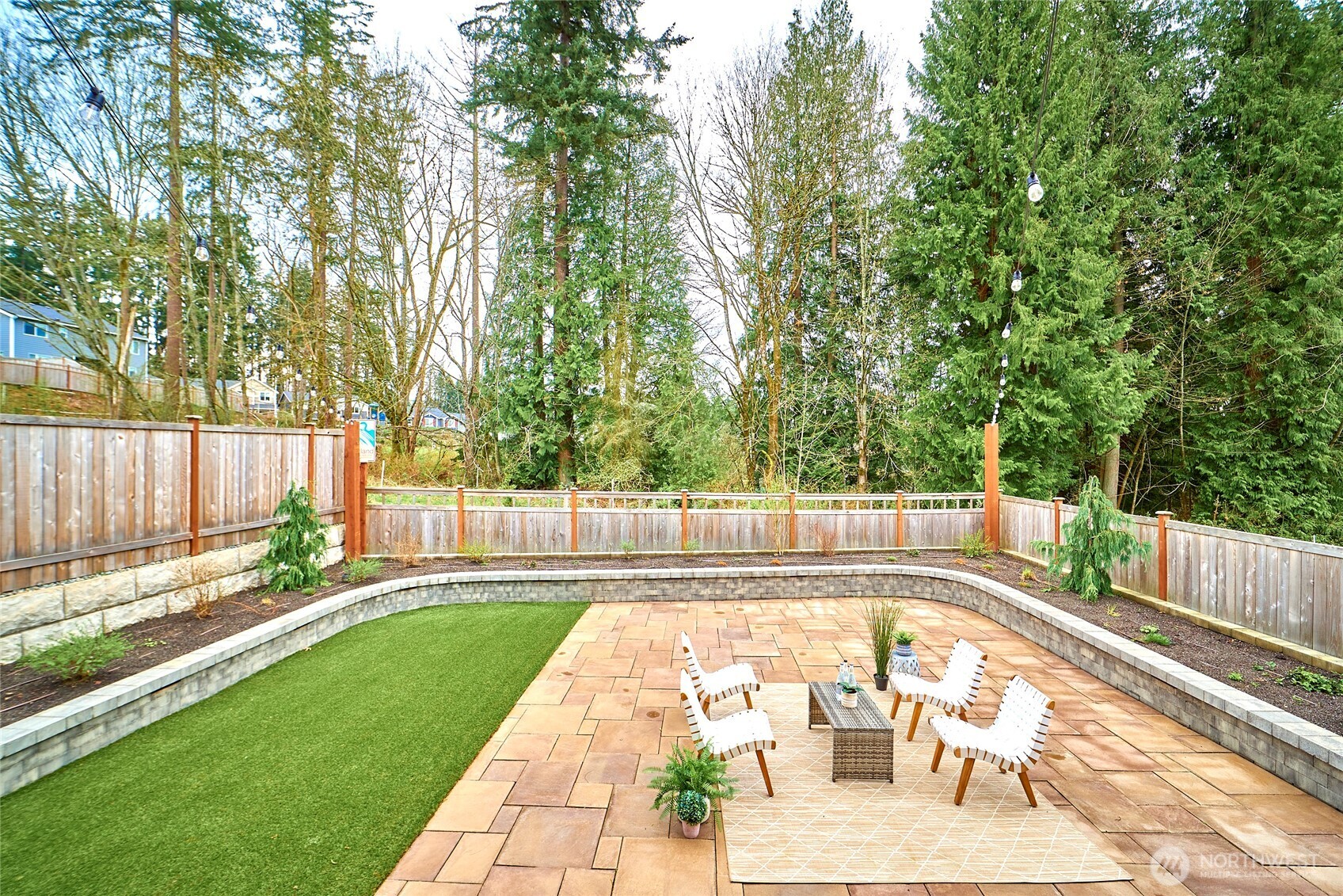 4022 233rd Street Southeast Bothell, WA 98021 - Photo 34 of 40 a view of a swimming pool with a patio and wooden fence