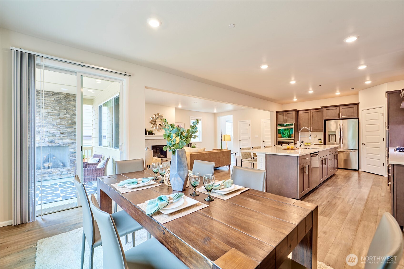 4022 233rd Street Southeast Bothell, WA 98021 - Photo 9 of 40 a kitchen with a dining table chairs and refrigerator