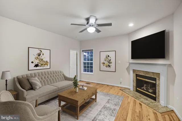 an empty room with windows and fireplace