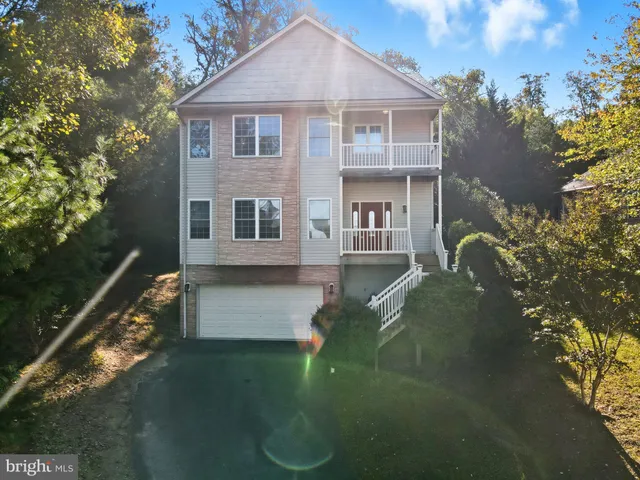 an aerial view of a house with a yard and garden