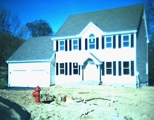 19 Taylor Court Ridgefield, CT 06877 - Photo 1 of 1 a front view of a house with a yard