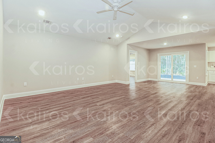 155 Cottage Grove Road Brunswick, GA 31525 - Photo 5 of 16 an empty room with wooden floor and windows