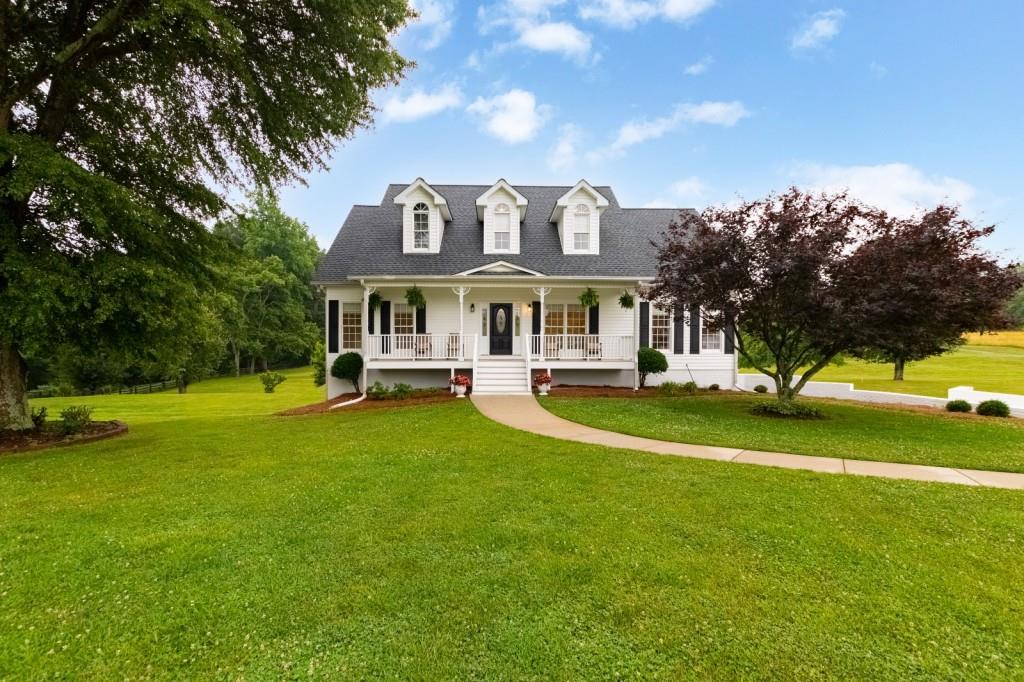 286 Gantt Road Canton, GA 30115 - Photo 1 of 1 a front view of a house with a garden and swimming pool