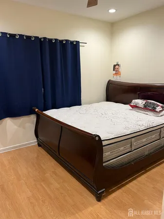 a bedroom with a bed and cabinet