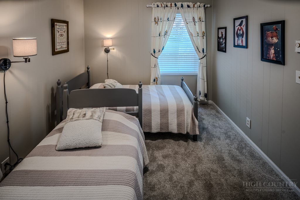38 Rocky Meadows Road Newland, NC 28657 - Photo 30 of 50 a bedroom with a bed and night stand