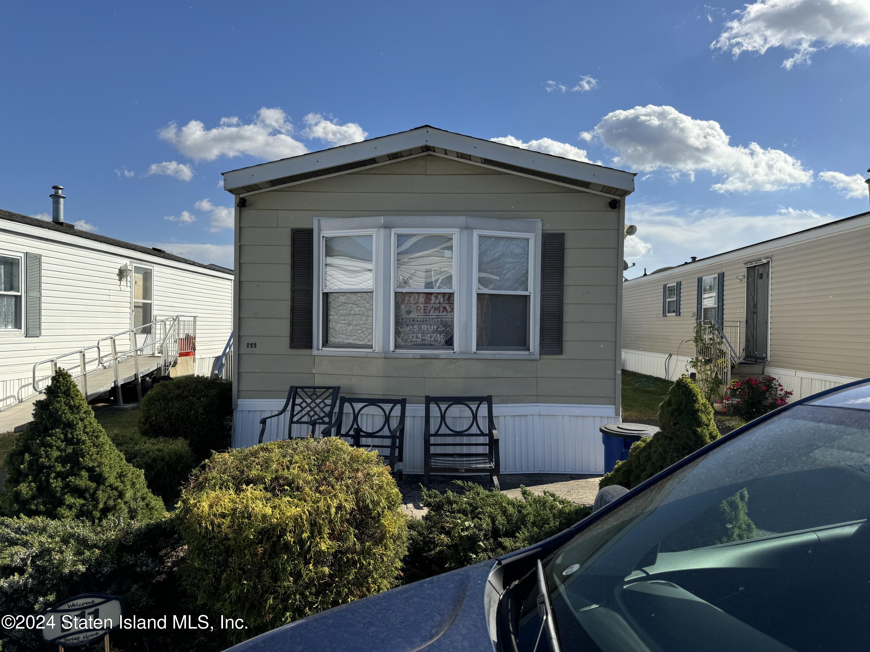 2701 Goethals Road North, Unit D11 Staten Island, NY 10303 - Photo 1 of 9 a front view of a house with a yard