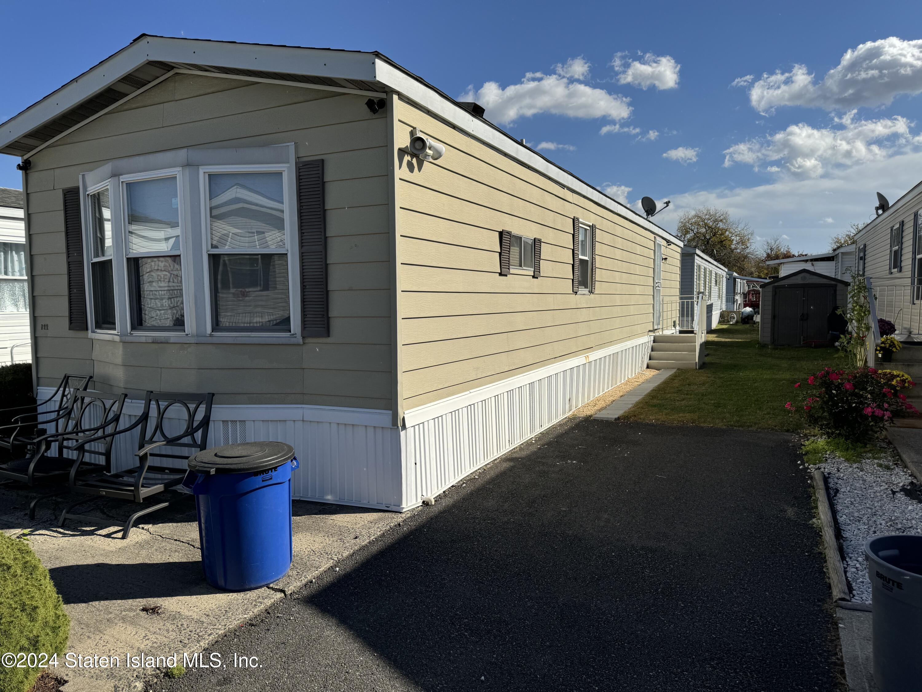 2701 Goethals Road North, Unit D11 Staten Island, NY 10303 - Photo 2 of 9 a front view of a house with a yard