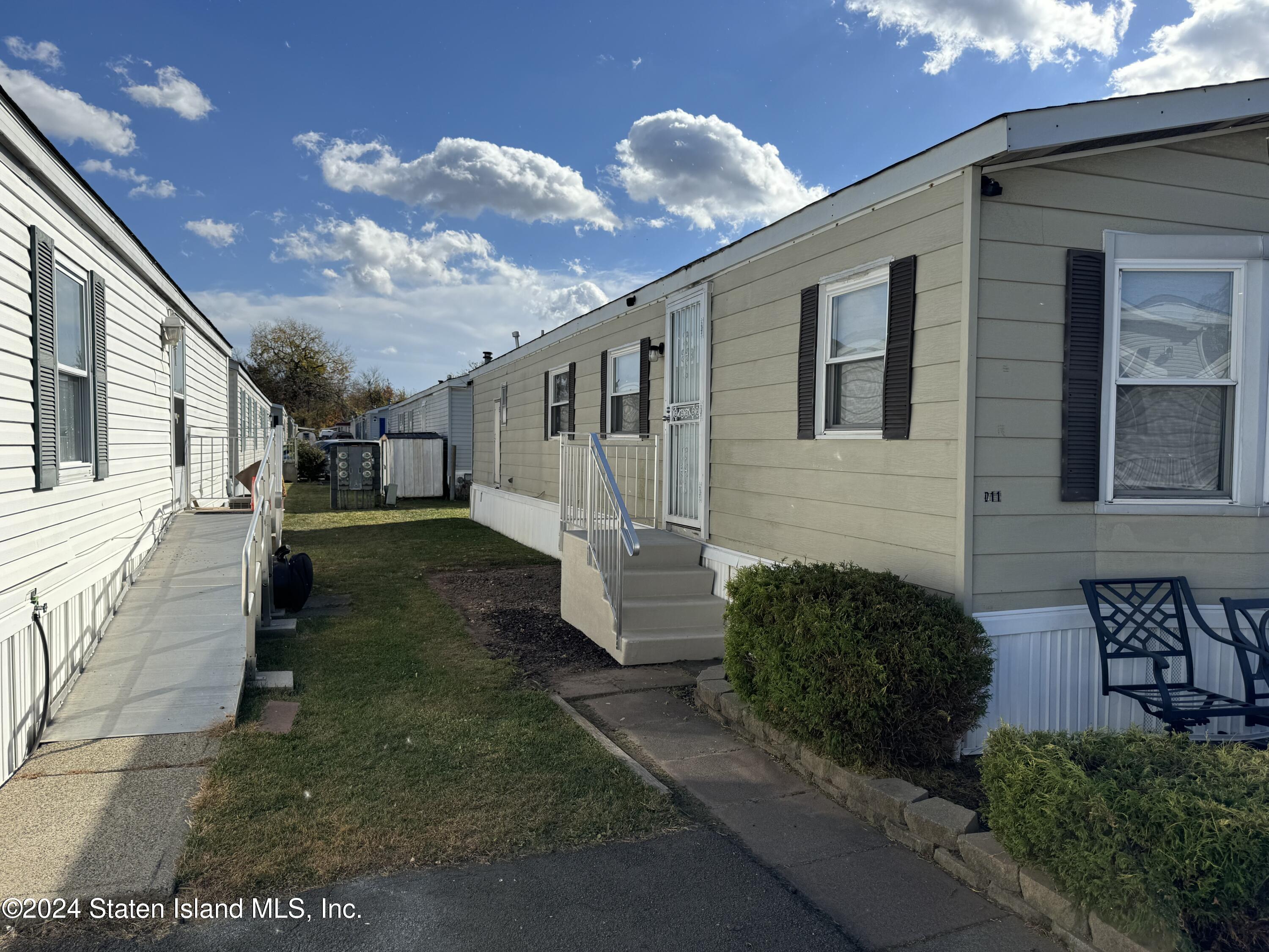 2701 Goethals Road North, Unit D11 Staten Island, NY 10303 - Photo 3 of 9 a view of a house with a yard