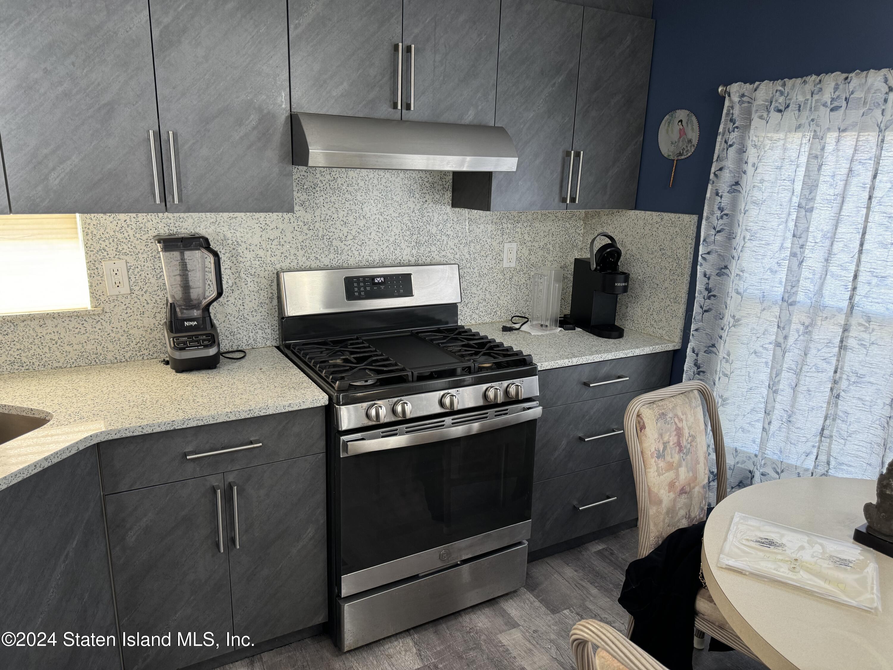 2701 Goethals Road North, Unit D11 Staten Island, NY 10303 - Photo 4 of 9 a kitchen with stainless steel appliances granite countertop a stove a sink and a refrigerator