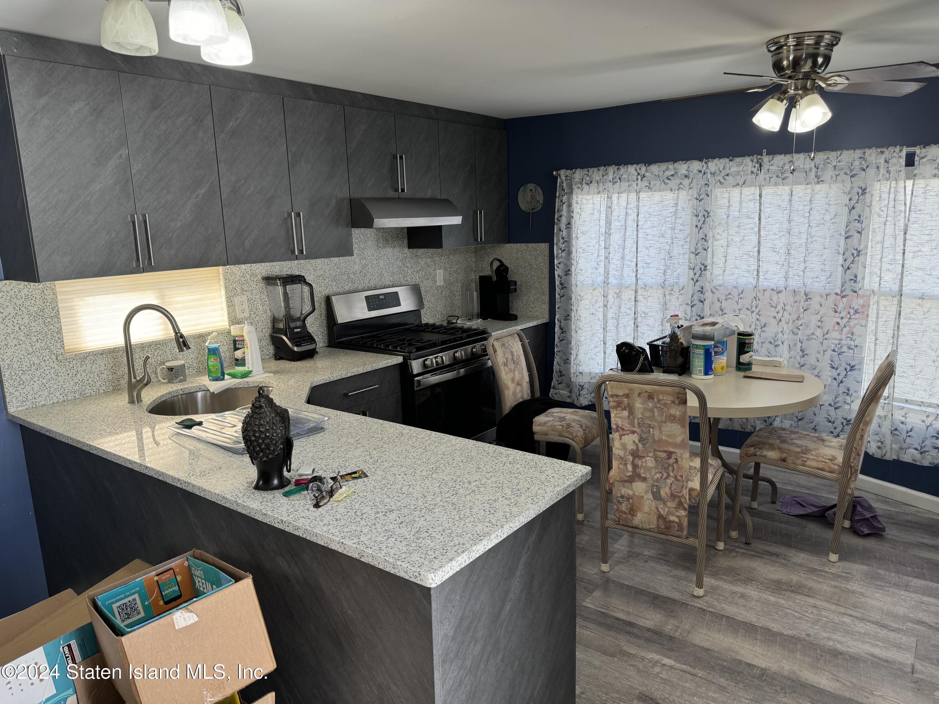 2701 Goethals Road North, Unit D11 Staten Island, NY 10303 - Photo 5 of 9 a kitchen with a dining table chairs and refrigerator