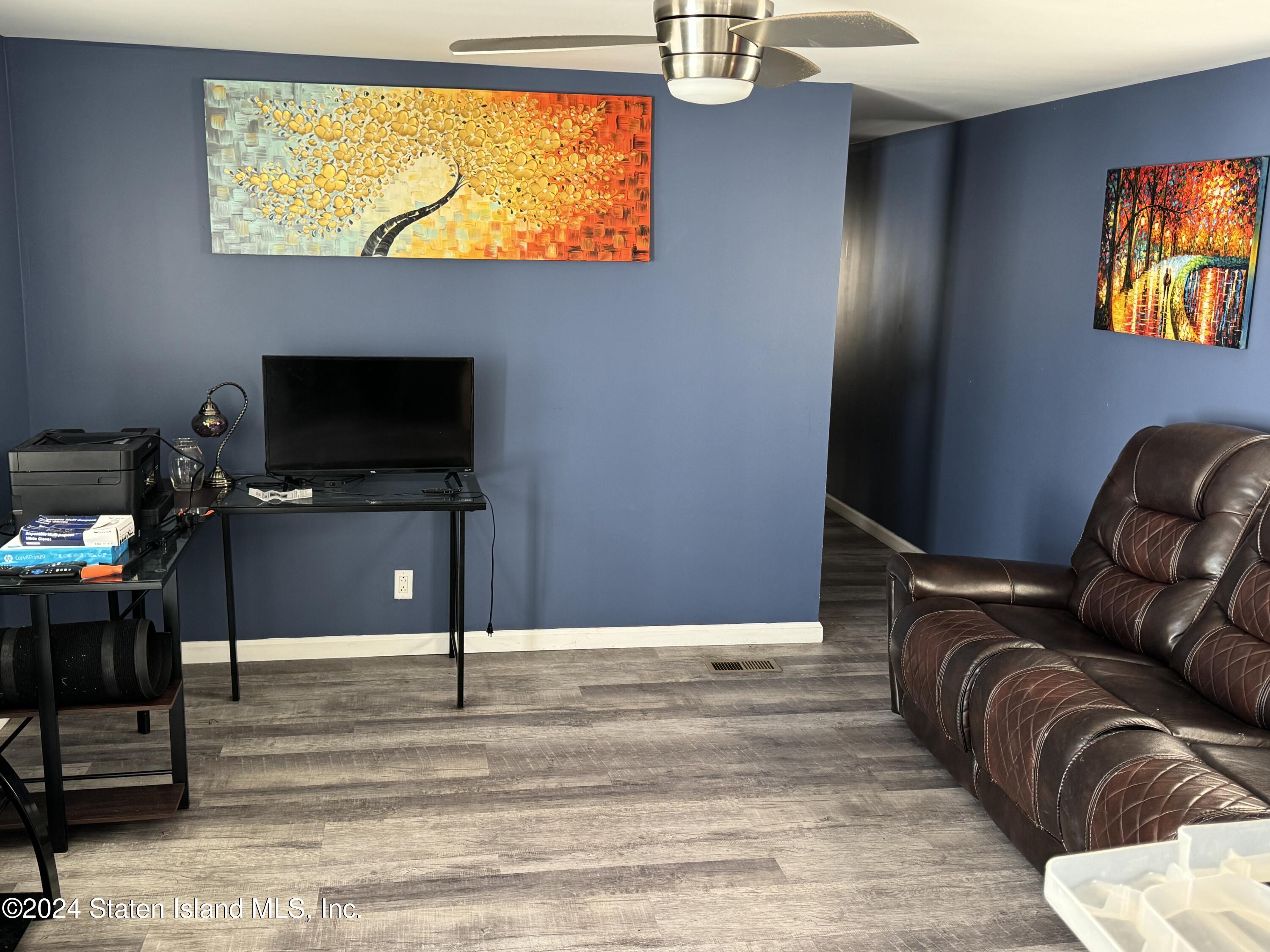 2701 Goethals Road North, Unit D11 Staten Island, NY 10303 - Photo 8 of 9 a view of a livingroom with furniture and a flat screen tv