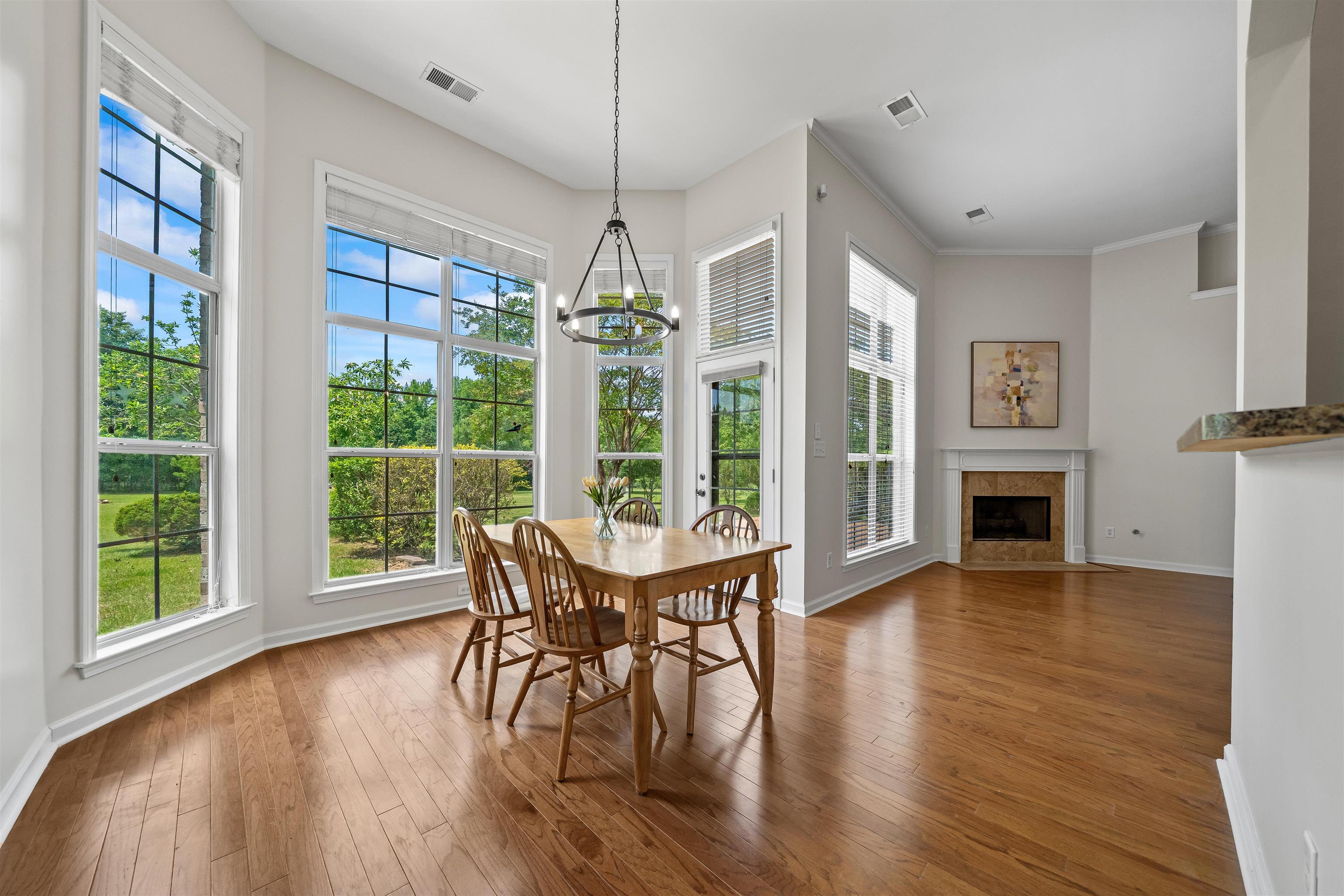 5035 Brian Ridge Road Arlington, TN 38002 - Photo 9 of 40 Bay window dining space with wood-finish flooring, featuring a contemporary chandelier and abundant natural light