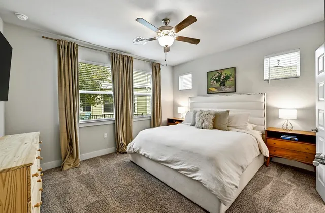 a bedroom with a bed and a large window