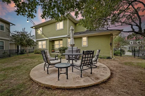 a view of a house with backyard porch and sitting area